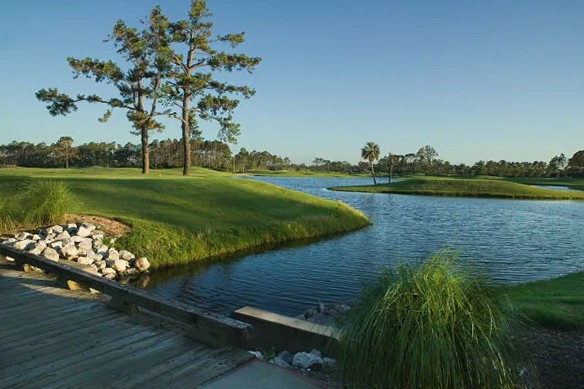 Perdido Bay Golf Club fairway beside a still lagoon